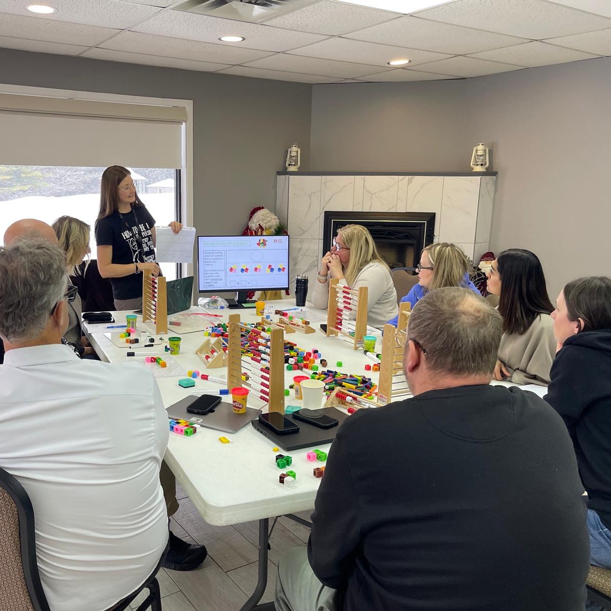 Educators sit at a table while engaging in professional learning