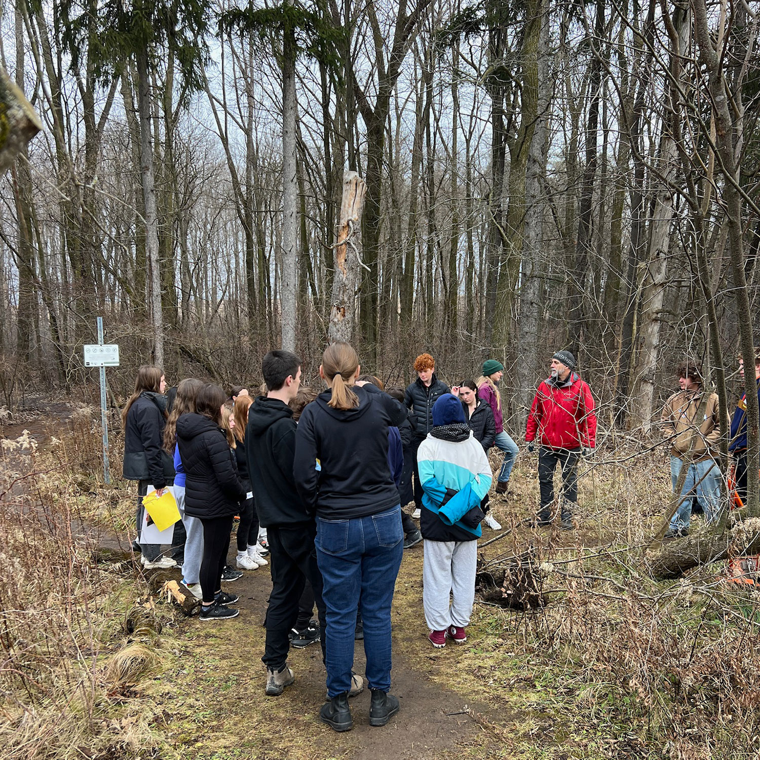 Students and staff are pictured in the forest at the Arboretum in Guelph.