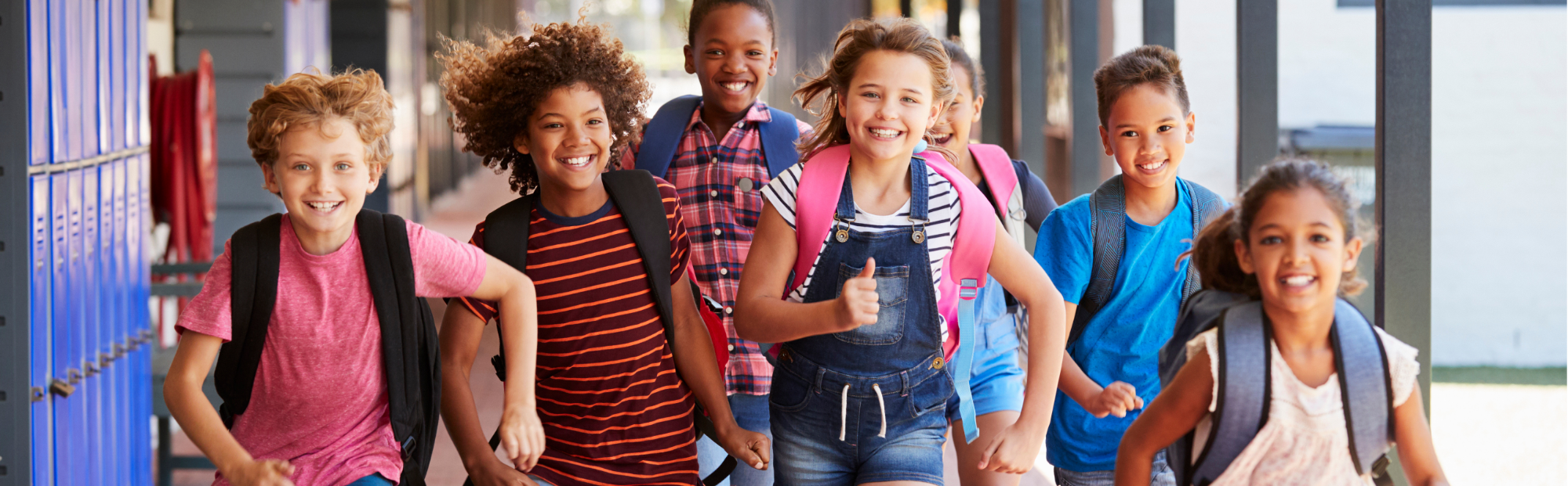 Happy children running at a school