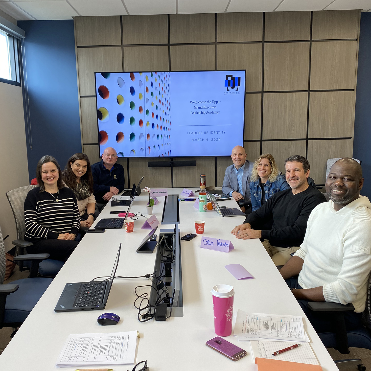 Members of the 2023-24 UGELA cohort sit around a meeting table