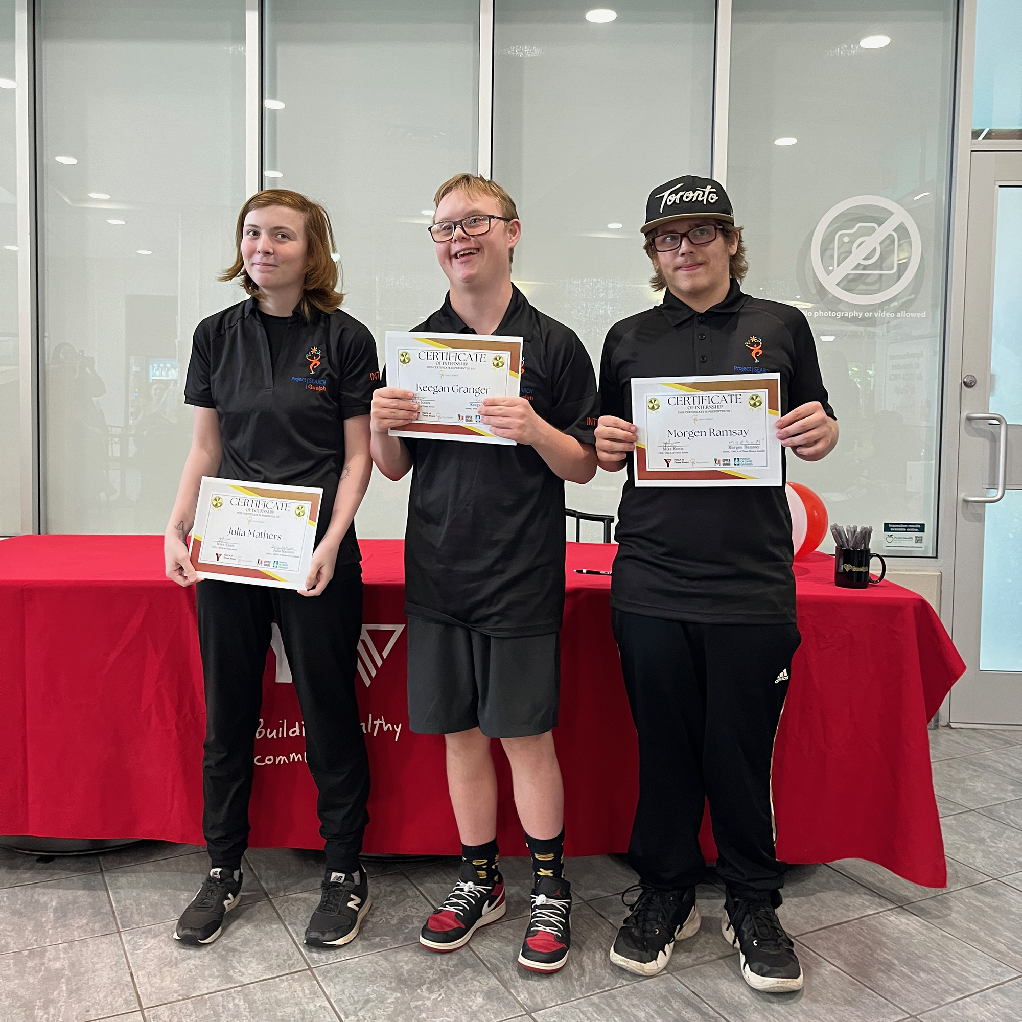 3 Project Search students hold up their certificates. 