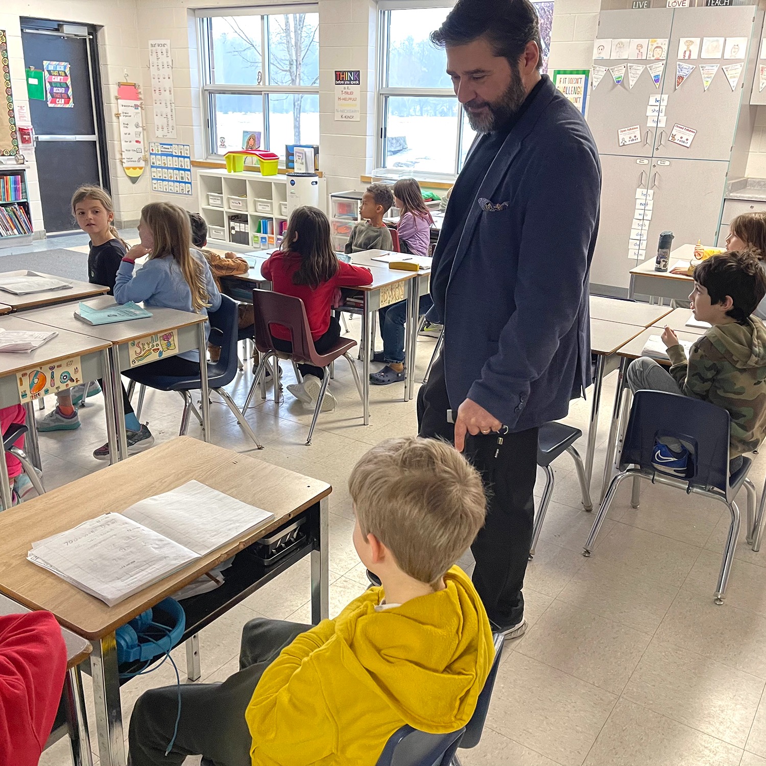 Director Sovran pictured in a classroom with students. 