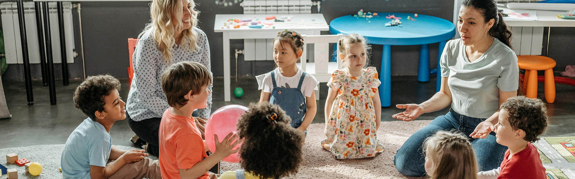 Kids with their Teacher Sitting on the Floor