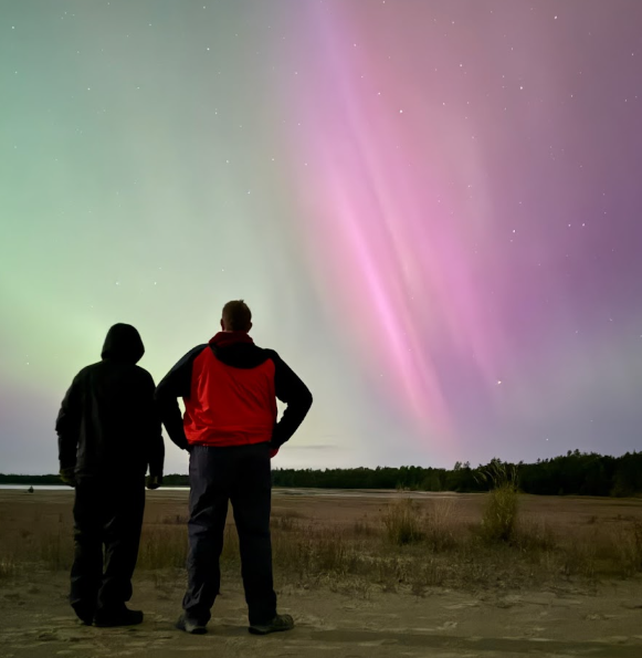 Two people looking at the Northern Lights
