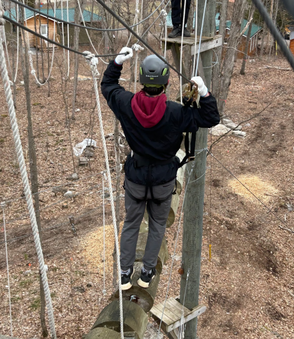 A student participating in a Treetop Trekking class.