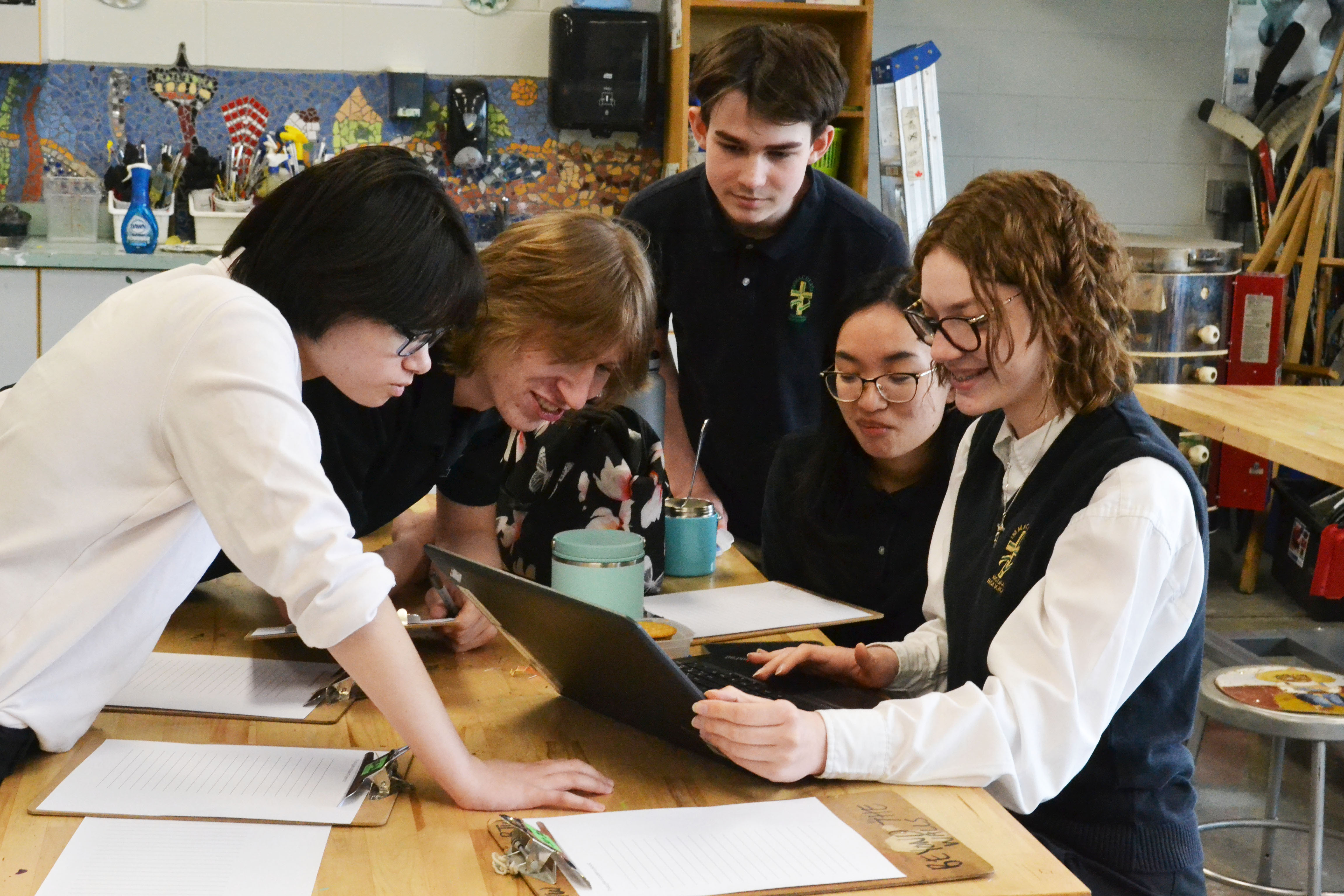 Students working at a desk in a group