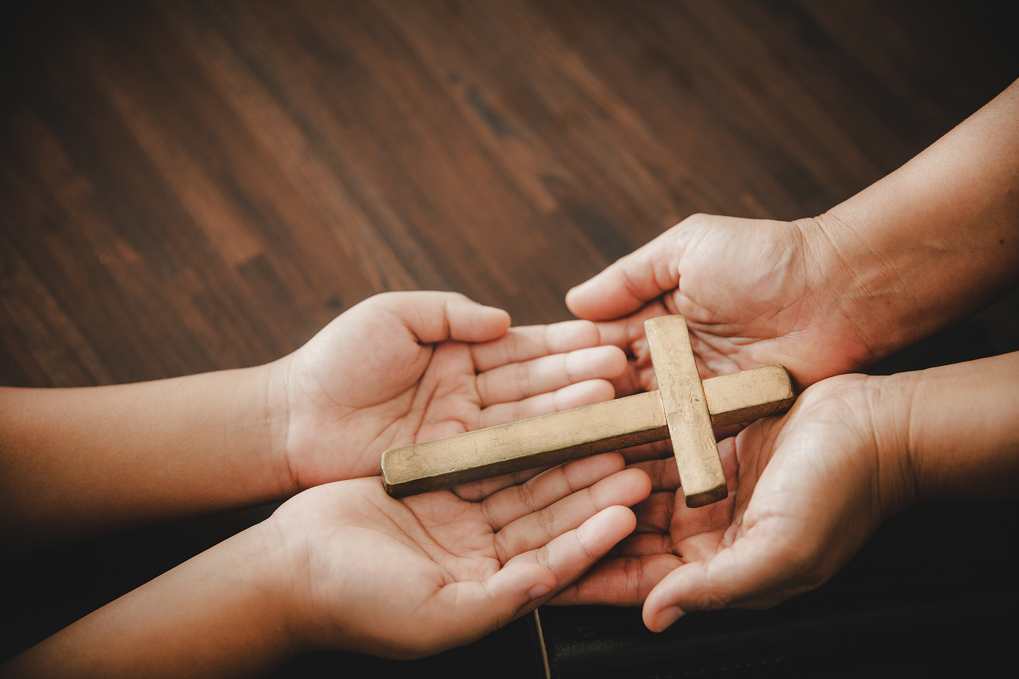 Hands holding a cross