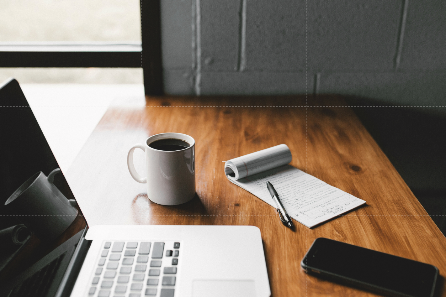 laptop, phone, pen, tablet and coffee on a desk