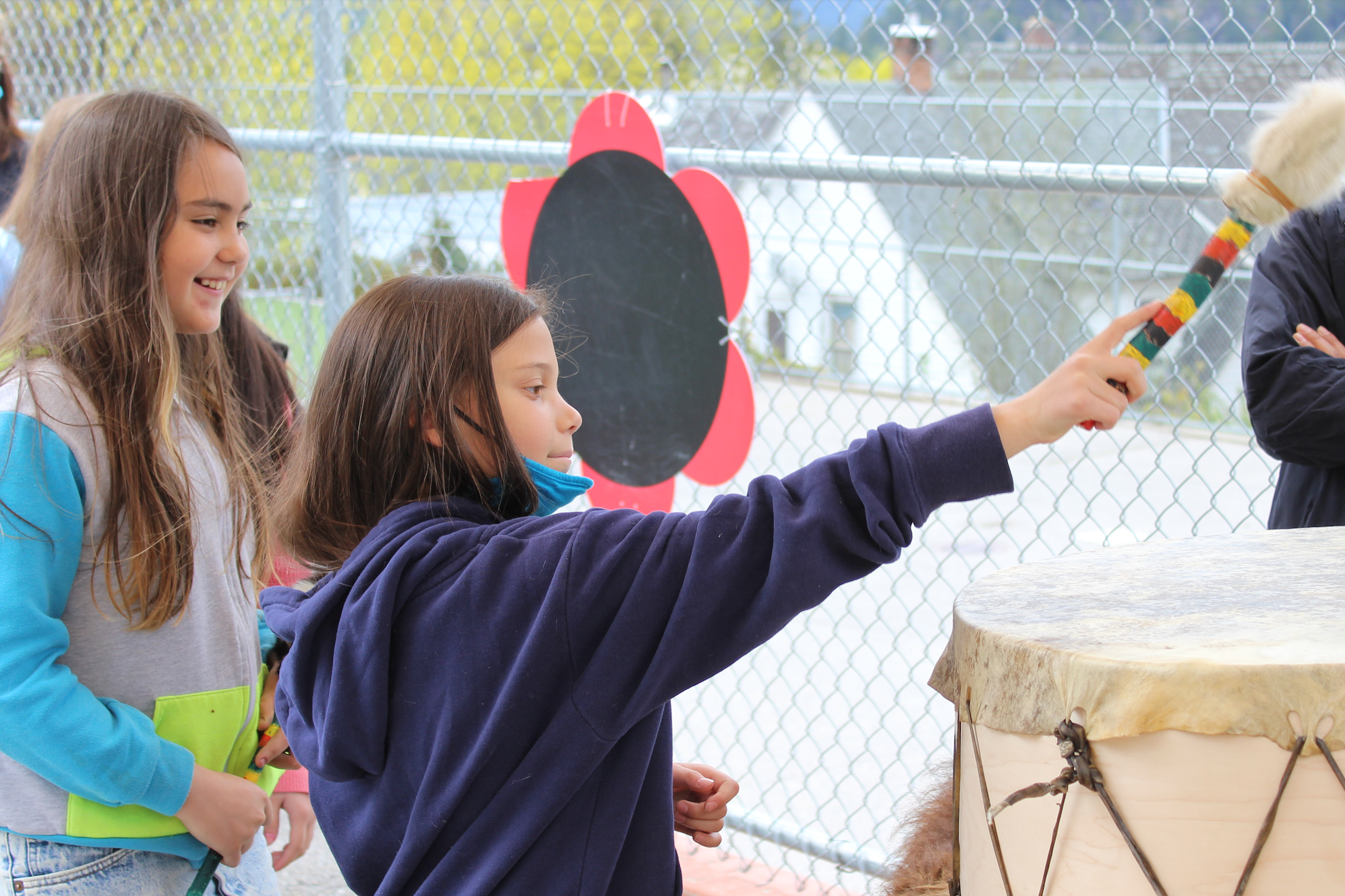 students banging drum