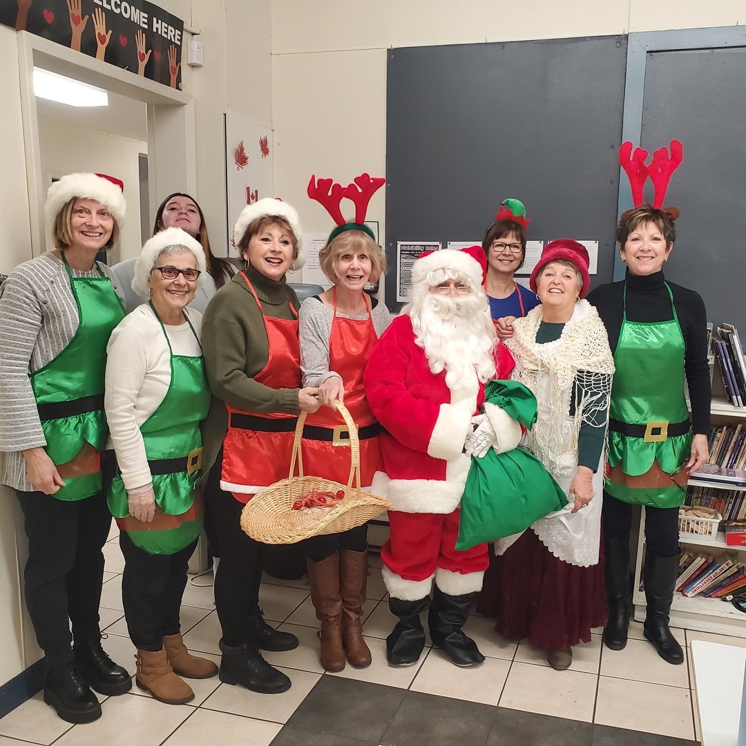 Ladies dressed up as elves with santa