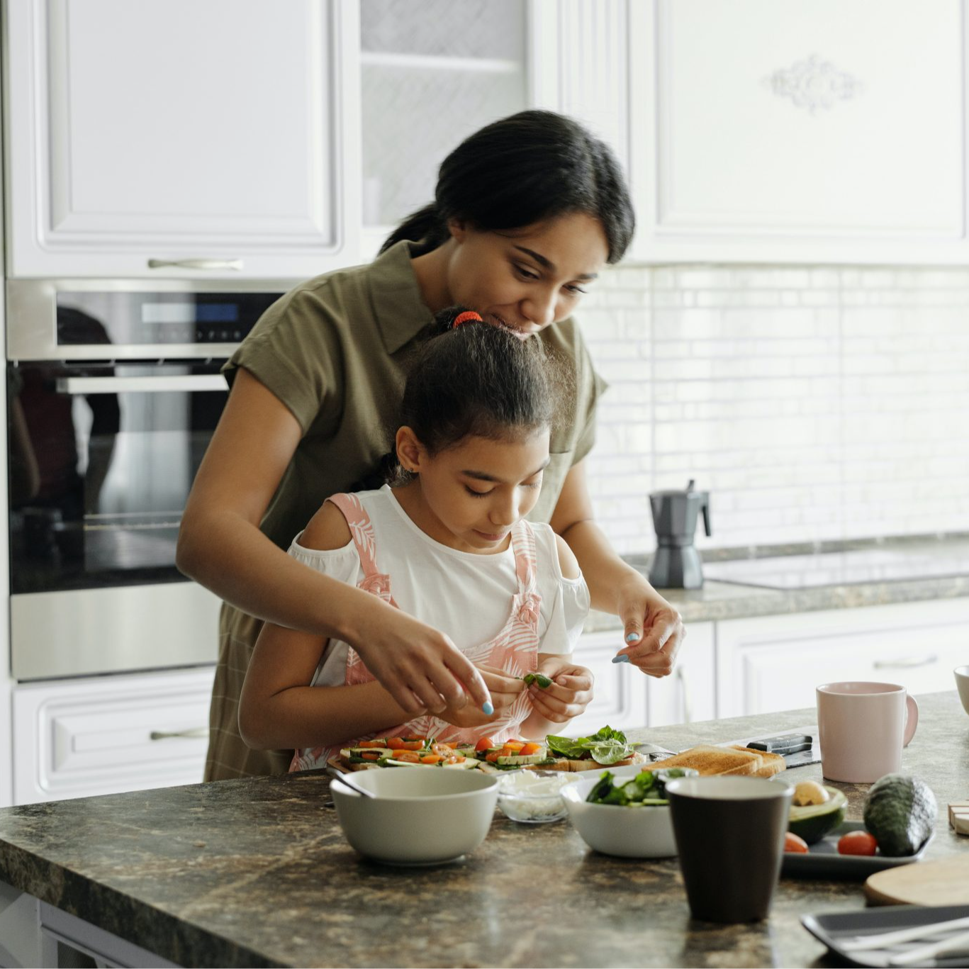 mom and daughter cooking