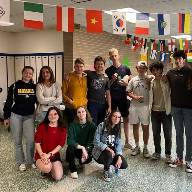 International students in front of school lockers while attending a cultural event