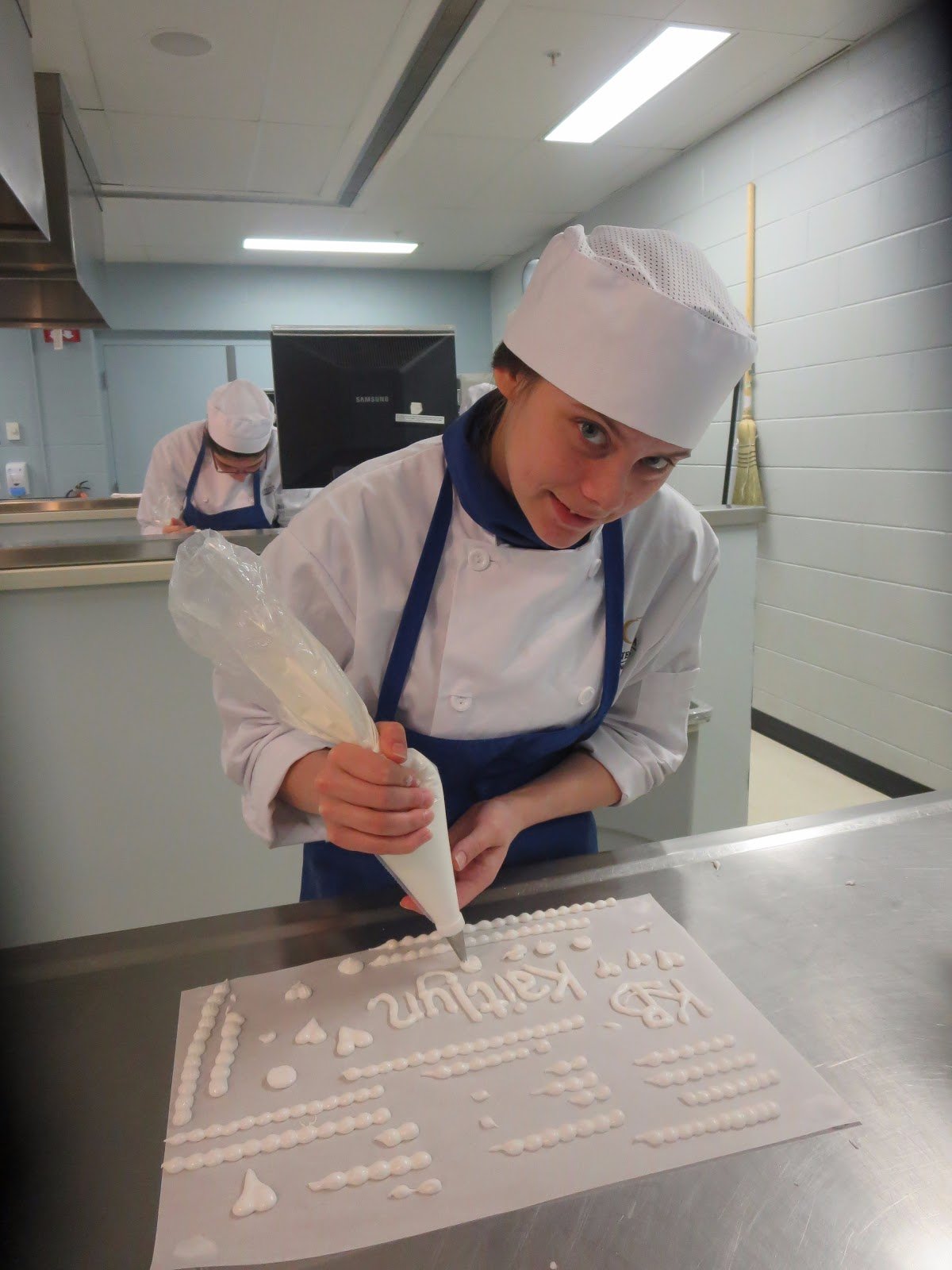 Student putting frosting