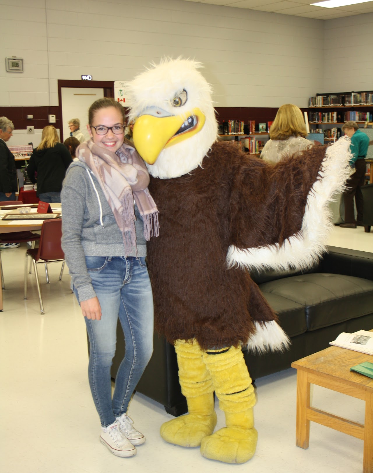 family taking a picture with the mascot