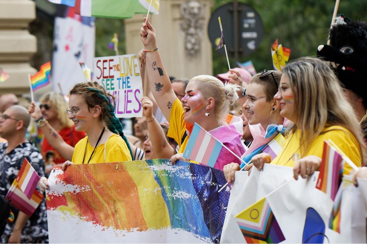 People carrying flags and celebrating during a Pride Parade