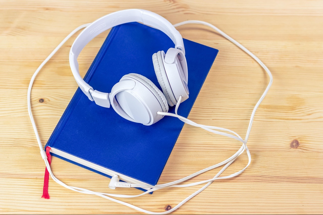 Blue book with white headphones 