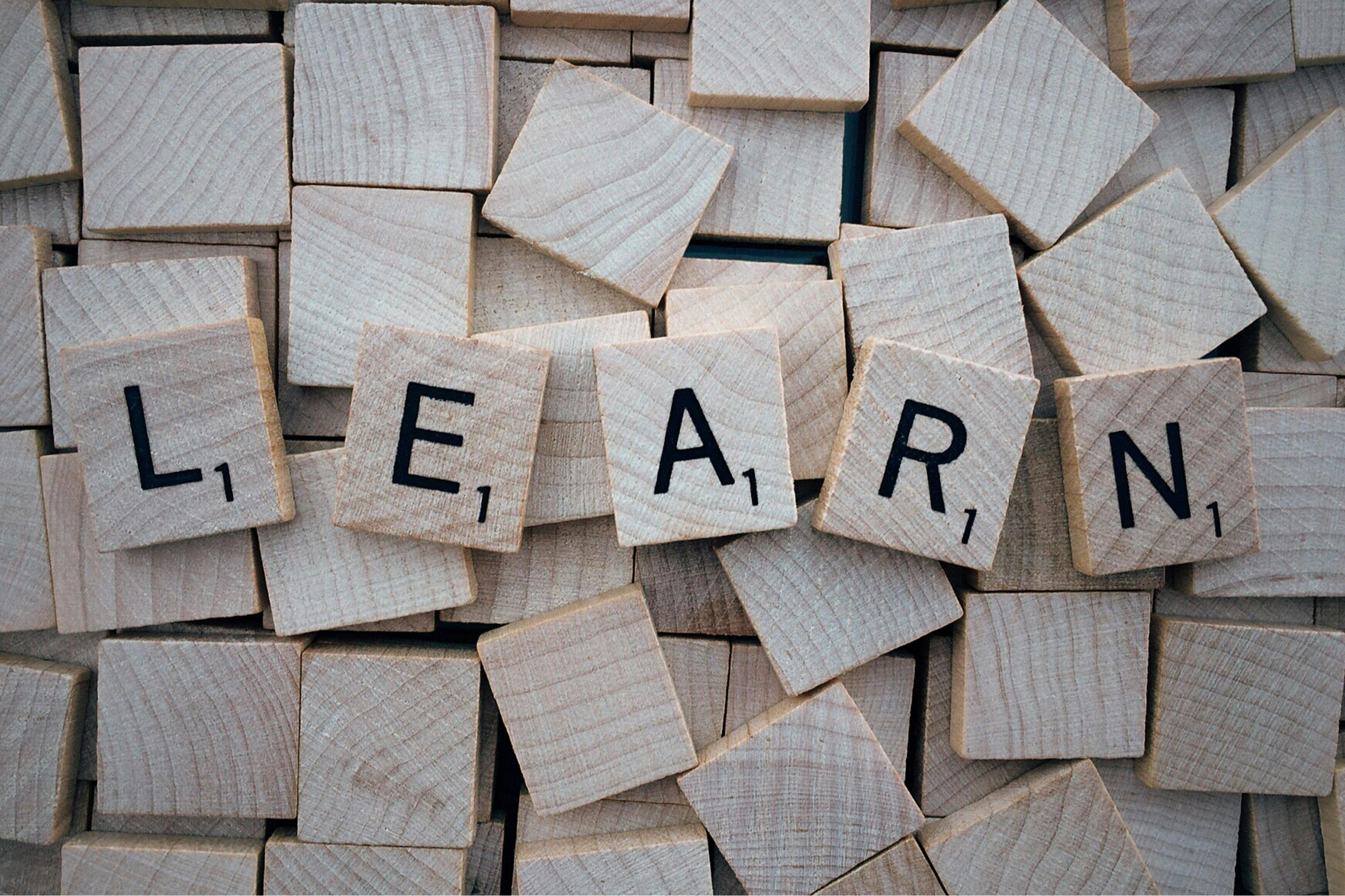 Wooden letter tiles spelling "learn"