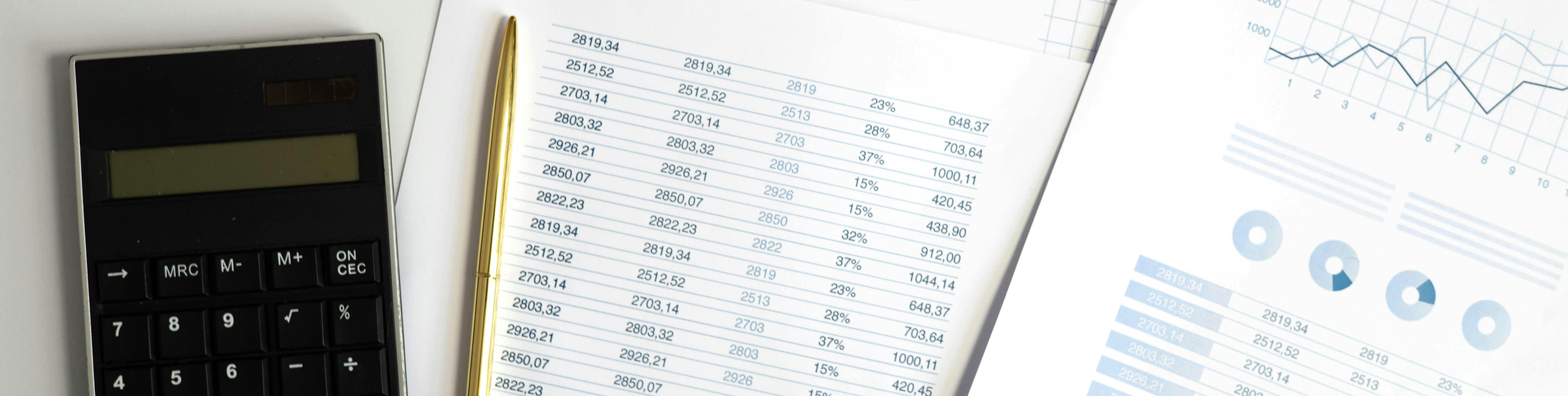 Accounting documents with a calculator and pen