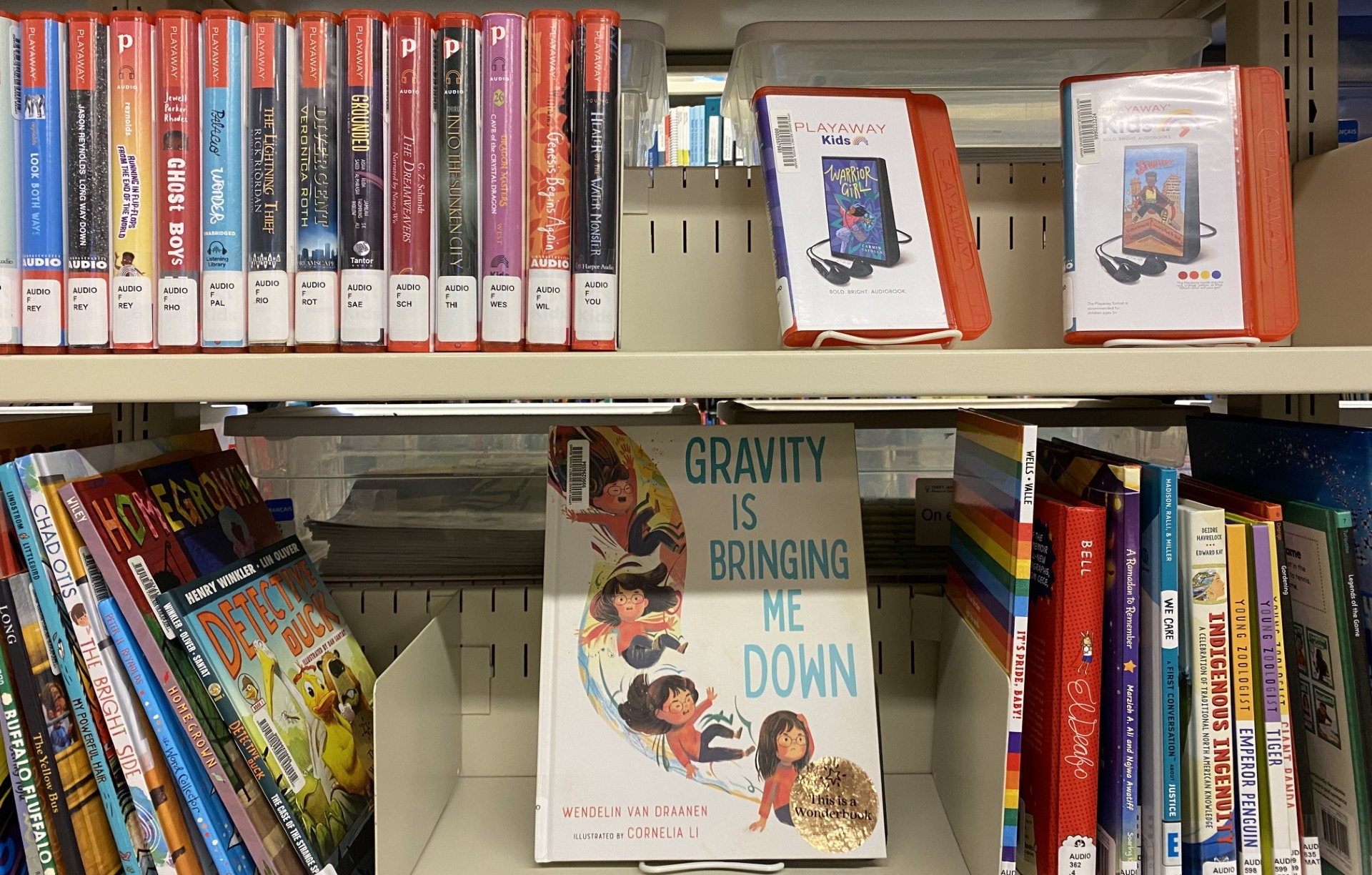 Photo of shelves holding Playaways and Wonderbooks at TJRC