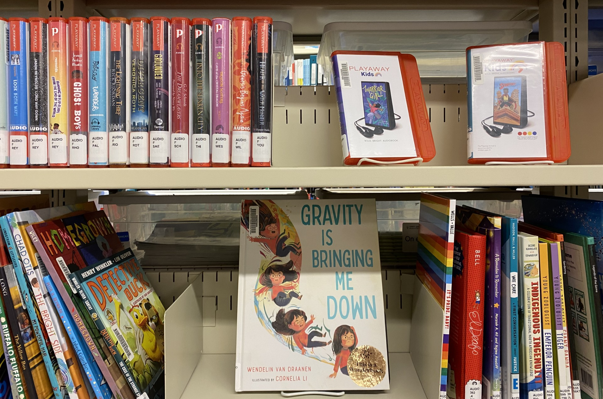 Photo of shelves holding Playaways and Wonderbooks at TJRC